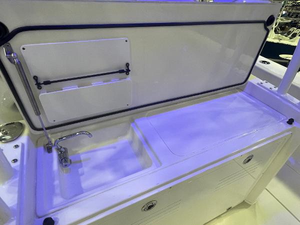 Slide: The Image of 2023 Cobia 350 Center Console boat sink and storage area. - 22
