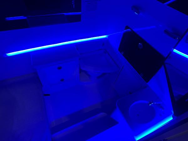 Slide: The Image of 2023 Cobia 350 Center Console interior with blue LED lighting. - 24