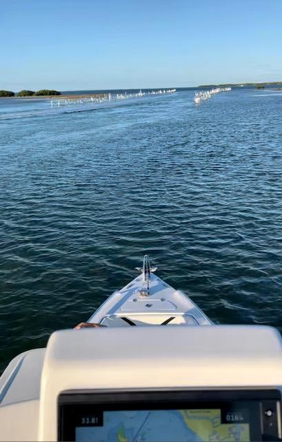 Slide: The Image of View from Concept 27 boat navigating through calm waters, 2023 model. - 10