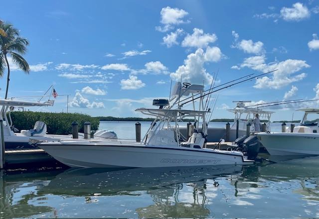Slide: The Image of 2023 Concept 27 boat docked at marina under clear blue sky. - 11