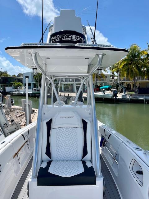 Slide: The Image of 2023 Concept 27 boat at a marina, featuring a sleek design and comfortable seating. - 6
