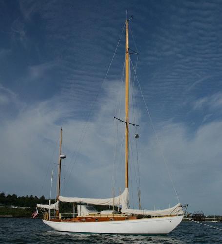 Slide: The Image of 1958 Concordia Yawl sailboat on calm waters under a clear sky. - 1