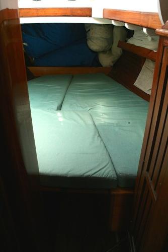 Slide: The Image of 1958 Concordia Yawl cabin with a cozy bed and wooden interior. - 8