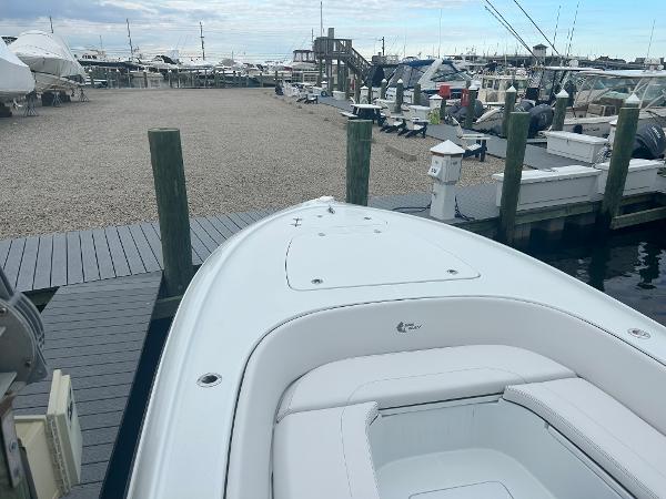 Slide: The Image of 2022 Contender 25 Bay boat docked at a marina. - 10