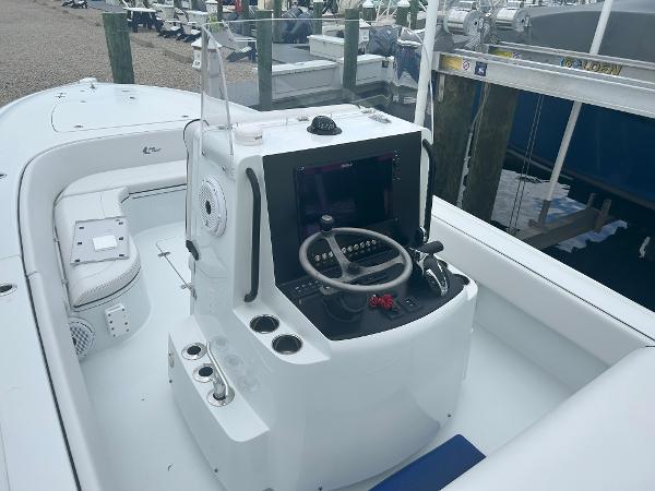 Slide: The Image of 2022 Contender 25 Bay boat console with steering wheel and controls. - 13
