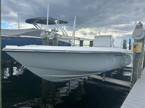 Slide: The Image of 2022 Contender 25 Bay boat docked at a marina under cloudy skies. - 14