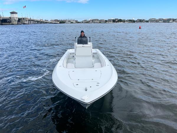 Slide: The Image of 2022 Contender 25 Bay boat on open water with a person at the helm. - 3