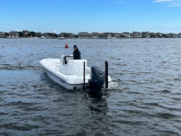 Slide: The Image of 2022 Contender 25 Bay boat cruising on a coastal waterway. - 4