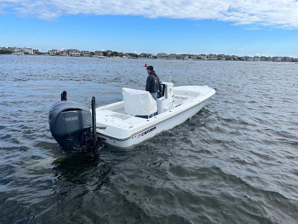 Slide: The Image of 2022 Contender 25 Bay boat on water with Yamaha outboard motor. - 5