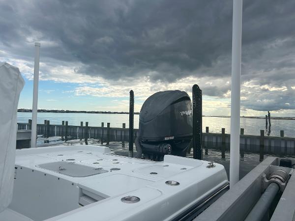 Slide: The Image of 2022 Contender 25 Bay boat docked under cloudy sky. - 9
