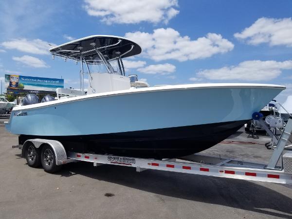 Slide: The Image of 2024 Contender 25 Tournament boat on a trailer under a blue sky. - 0