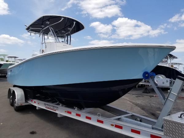 Slide: The Image of 2024 Contender 25 Tournament boat on trailer under blue sky. - 1