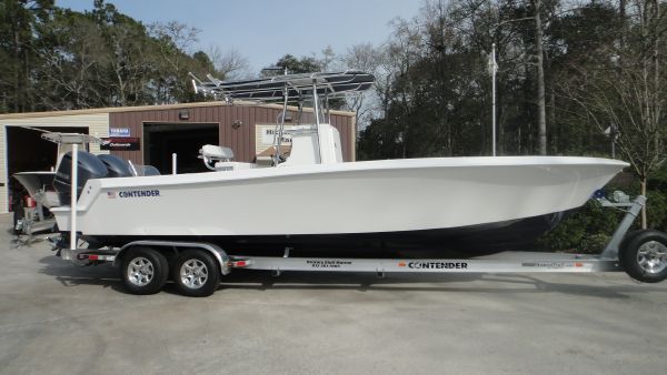 Slide: The Image of 2024 Contender 28T boat on a trailer outside a storage facility. - 3