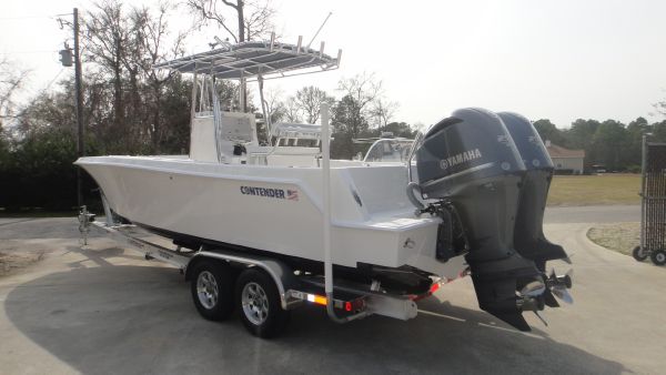 Slide: The Image of 2024 Contender 28T boat on trailer with twin Yamaha outboard engines. - 7