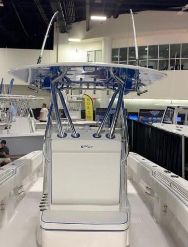 Slide: The Image of 2024 Contender 32 ST center console boat on display indoors. - 1