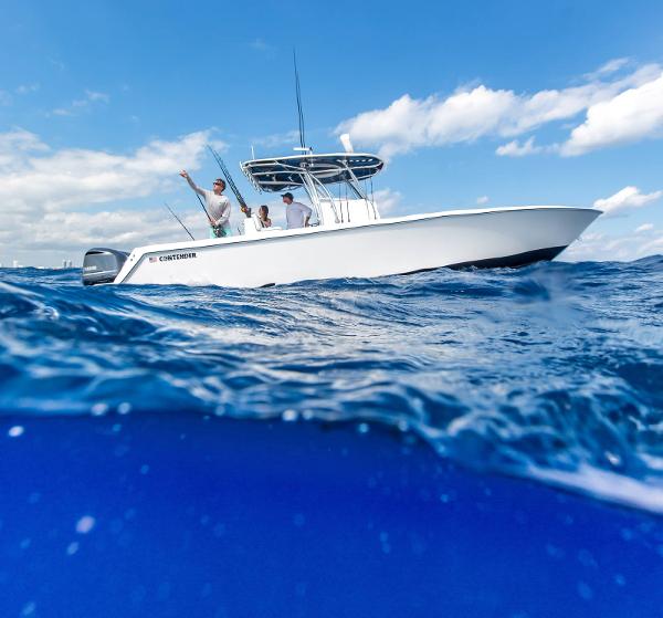 Slide: The Image of 2025 Contender 32 ST boat on open water with people fishing. - 11