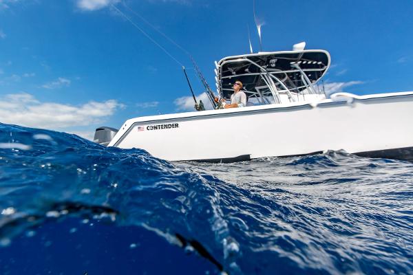 Slide: The Image of 2025 Contender 32 ST boat on the ocean with a person fishing. - 12