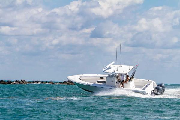 Slide: The Image of Contender 32 ST 2025 model boat cruising on open water. - 14