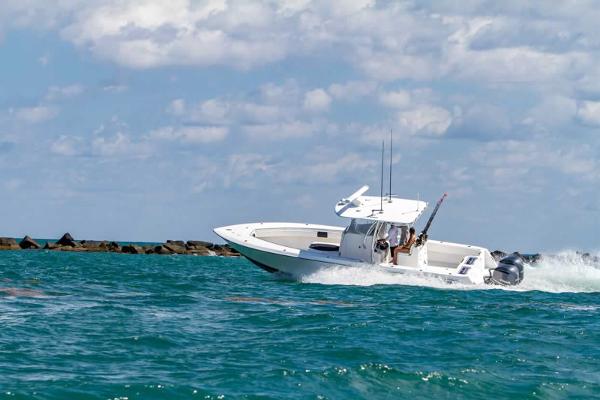 Slide: The Image of 2025 Contender 32 ST boat cruising on open water. - 15