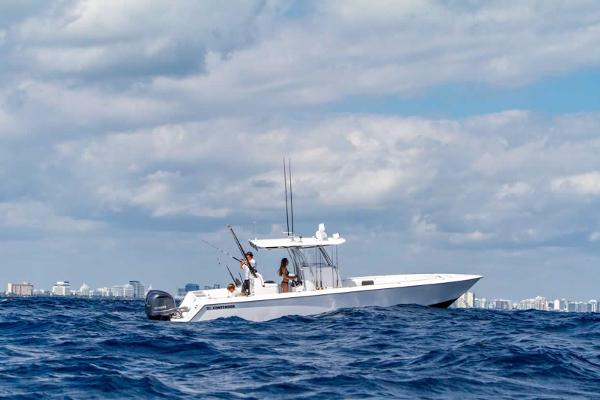 Slide: The Image of 2025 Contender 32 ST boat on open ocean with city skyline in background. - 18