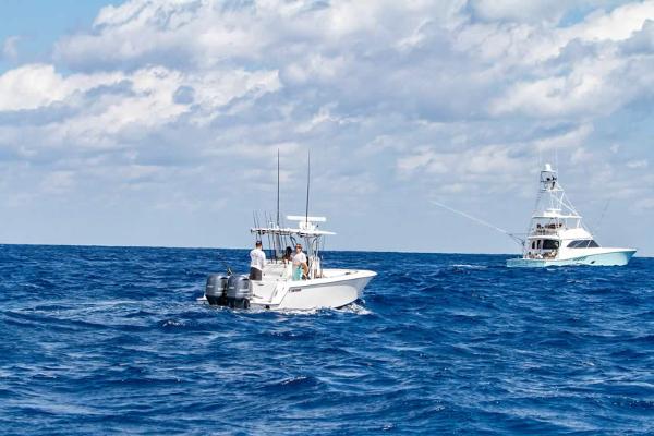 Slide: The Image of 2025 Contender 32 ST boat on open ocean with another boat in the background. - 19