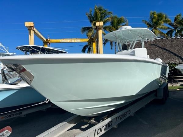 Slide: The Image of 2025 Contender 35 ST boat on trailer, sunny day, palm trees in background. - 13