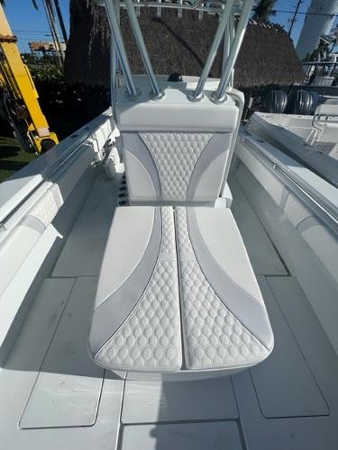 Slide: The Image of 2025 Contender 35 ST boat interior with white cushioned seating. - 15