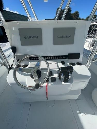 Slide: The Image of 2025 Contender 35 ST boat console with Garmin displays and steering wheel. - 18