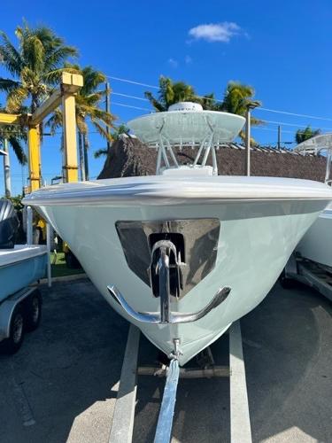 Slide: The Image of 2025 Contender 35 ST boat on trailer, sunny day, palm trees in background. - 23