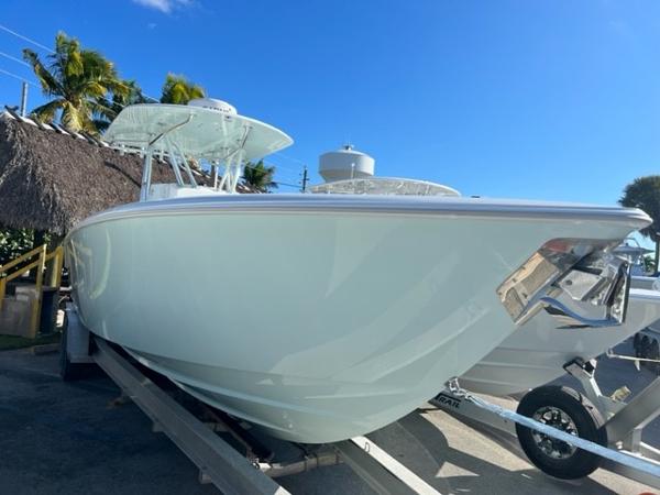Slide: The Image of 2025 Contender 35 ST boat on trailer, sunny day, palm trees in background. - 3