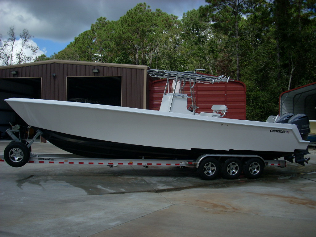 Slide: The Image of 2024 Contender 35 ST STEP HULL boat on a trailer in front of storage units. - 4