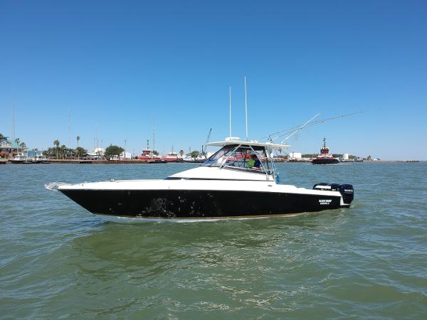 Slide: The Image of 2008 Contender 36 Fish Around boat on water with clear blue sky. - 17