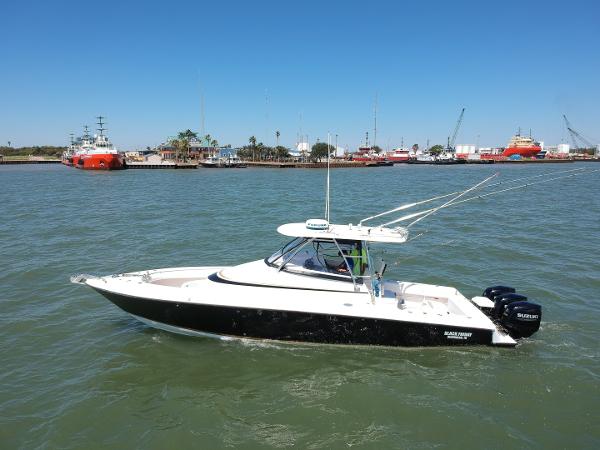 Slide: The Image of 2008 Contender 36 Fish Around boat on water with marina background. - 18