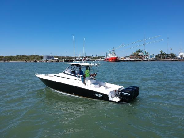 Slide: The Image of 2008 Contender 36 Fish Around boat on water with Suzuki outboard engines. - 19