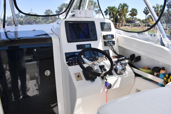Slide: The Image of 2008 Contender 36 Fish Around boat cockpit with navigation equipment and steering wheel. - 2