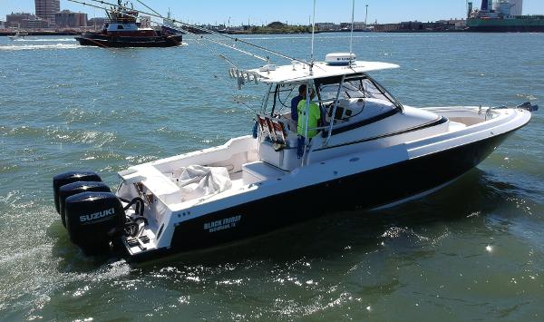 Slide: The Image of 2008 Contender 36 Fish Around boat with twin Suzuki outboard engines on the water. - 22