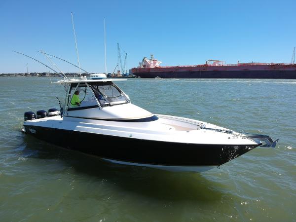 Slide: The Image of 2008 Contender 36 Fish Around boat on water, side view. - 23
