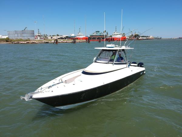 Slide: The Image of 2008 Contender 36 Fish Around boat on water near docks. - 26