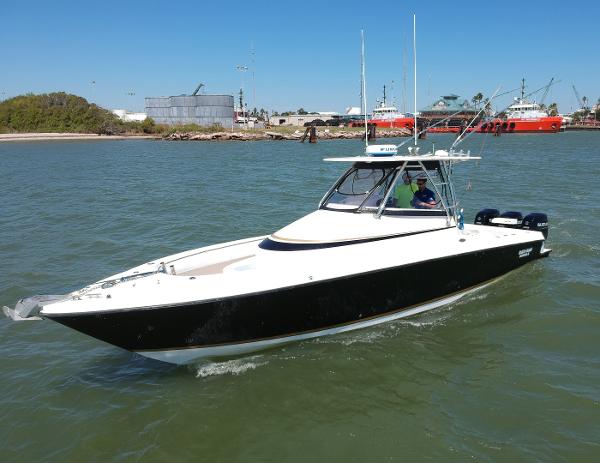 Slide: The Image of 2008 Contender 36 Fish Around boat cruising in a harbor. - 27