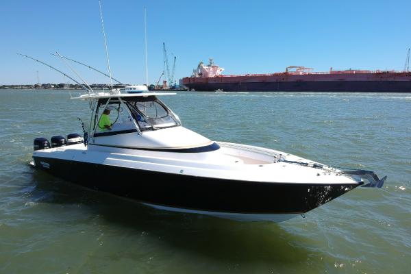 Slide: The Image of 2008 Contender 36 Fish Around boat on water with industrial background. - 29