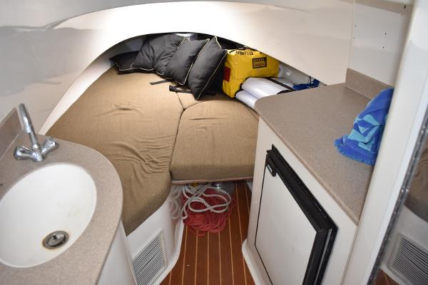 Slide: The Image of 2008 Contender 36 Fish Around cabin interior with bed, sink, and storage. - 3
