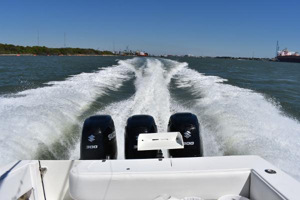 Slide: The Image of 2008 Contender 36 Fish Around with triple Suzuki 300 engines cruising on water. - 30