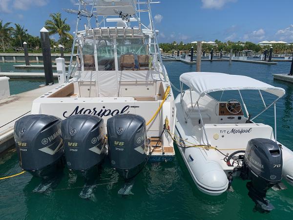 Slide: The Image of 2008 Contender 38 Express boat docked with Yamaha V6 engines. - 1