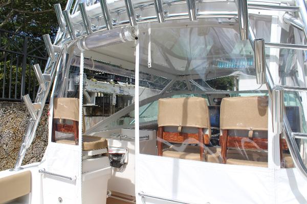 Slide: The Image of 2008 Contender 38 Express boat cockpit with seating and rod holders. - 10