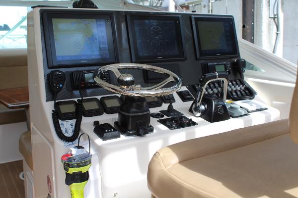 Slide: The Image of 2008 Contender 38 Express boat helm with advanced navigation systems and controls. - 15