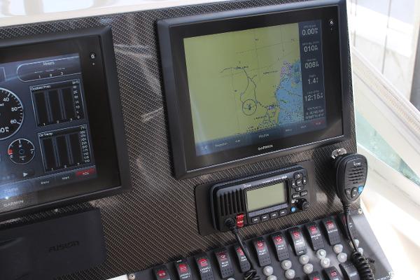 Slide: The Image of 2008 Contender 38 Express dashboard with Garmin navigation and communication equipment. - 16