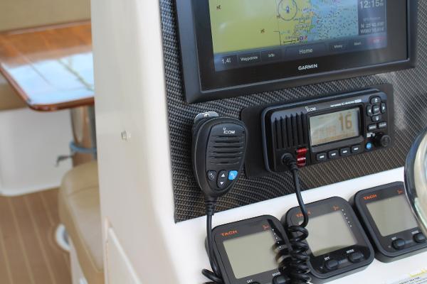 Slide: The Image of 2008 Contender 38 Express boat dashboard with Garmin GPS and Icom radio. - 17