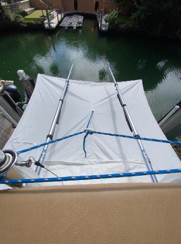 Slide: The Image of 2008 Contender 38 Express boat with a white canopy over water. - 23
