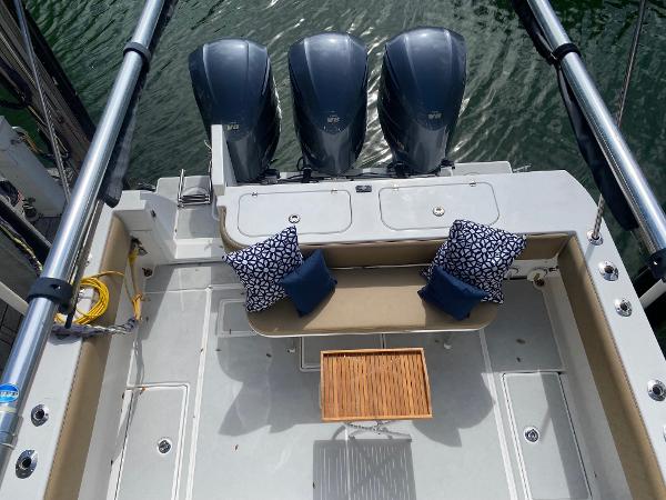 Slide: The Image of 2008 Contender 38 Express boat with triple outboard engines and cushioned seating. - 24