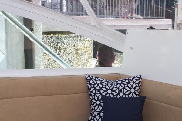 Slide: The Image of Interior seating area of a 2008 Contender 38 Express boat with decorative pillows. - 27